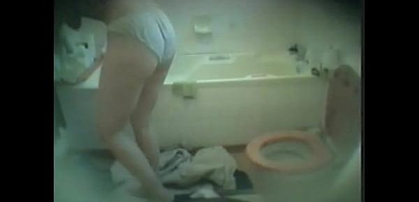  Big tits blonde MILF spied naked and getting dressed in the bathroom